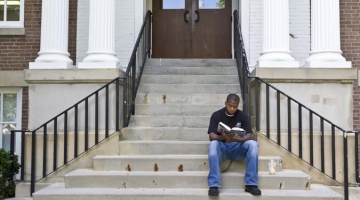 Student sitting on building steps